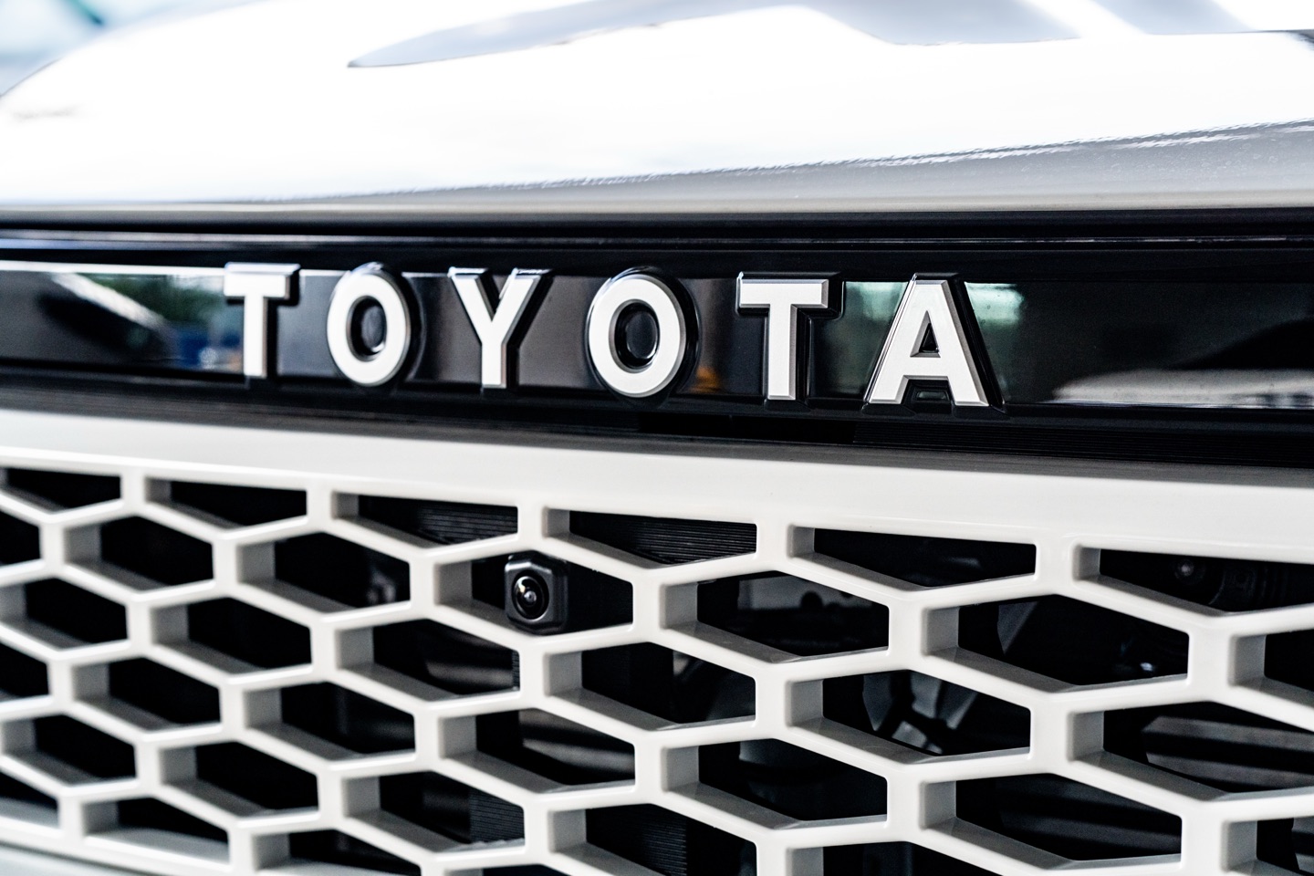 Close-up of the TOYOTA lettering on the Hilux grille
