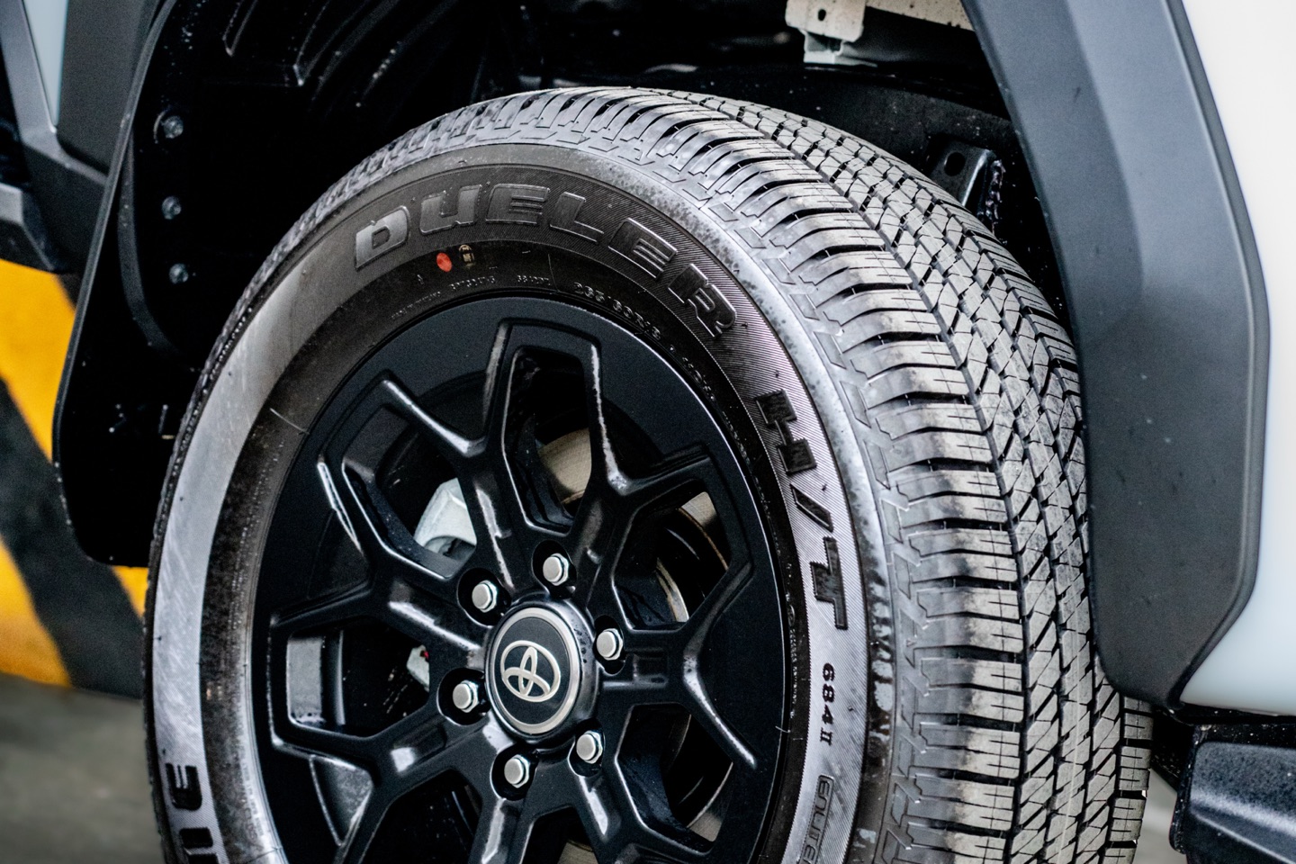 Black alloy wheel and all-terrain tyre on a Toyota Hilux