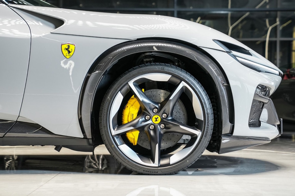 Ferrari shield on the front wing, above a carbon wheel arch and yellow brake caliper