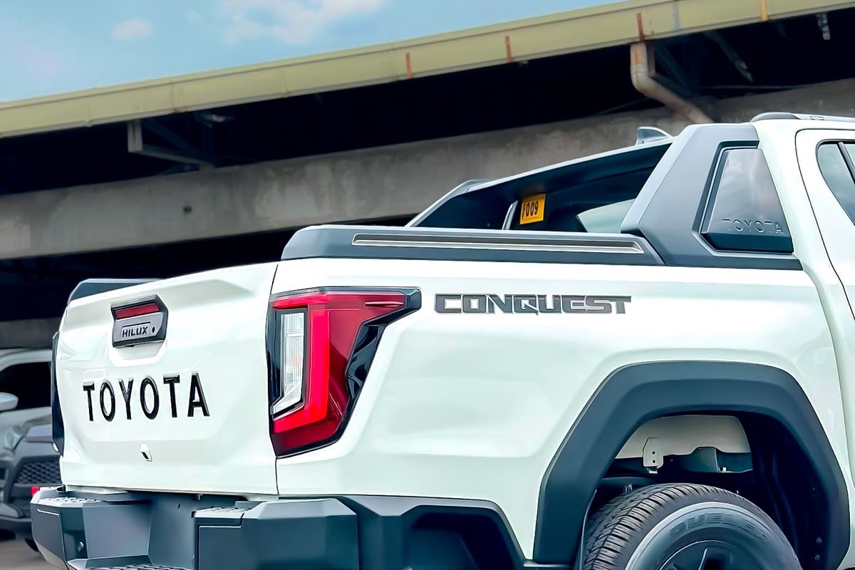 Rear three-quarter view of a brand-new white Toyota Hilux