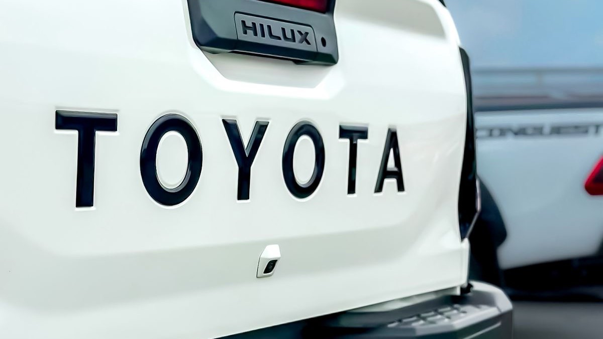 A Hilux being loaded onto a transport carrier at night